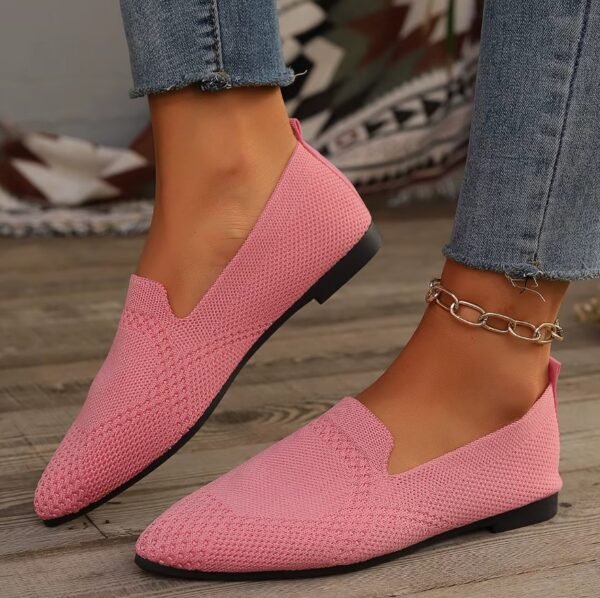 woman wearing light pink loafers and jeans