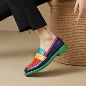 woman wearing one multicolor loafer