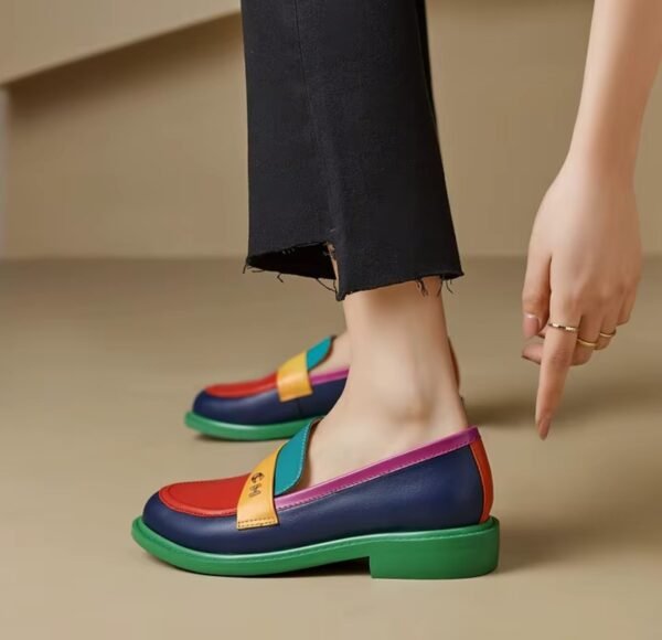 woman wearing multicolor loafers and black jeans