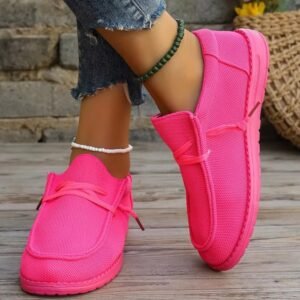 woman wearing neon pink sneakers and ankles bracelets