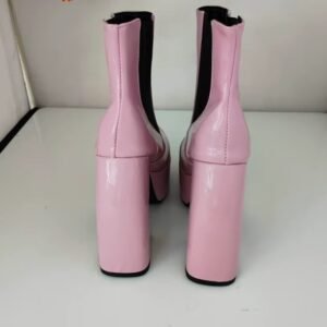 back side of pale pink boots standing on the white floor