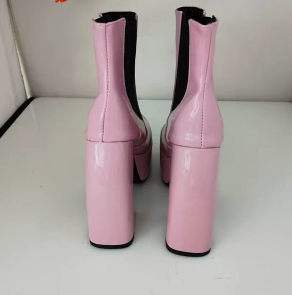 back side of pale pink boots standing on the white floor