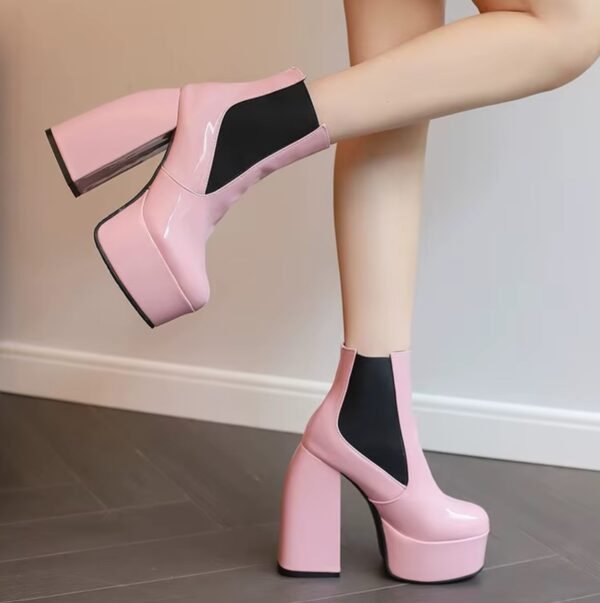 pale pink boots on feet side view, wooden floor under them