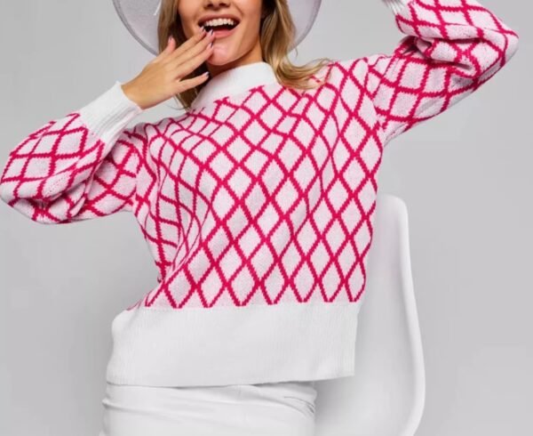 smiling woman wearing pink and white sweater and white skirt