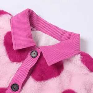 the collar and buttons of the pink cardigan with hearts