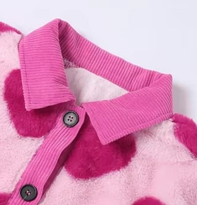 the collar and buttons of the pink cardigan with hearts