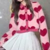 woman wearing pink cardigan with hearts