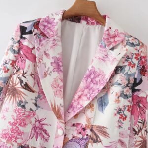 the upper part and the collar of the pink floral blazer on a hanger