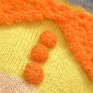 the orange buttons of the cute orange sweater