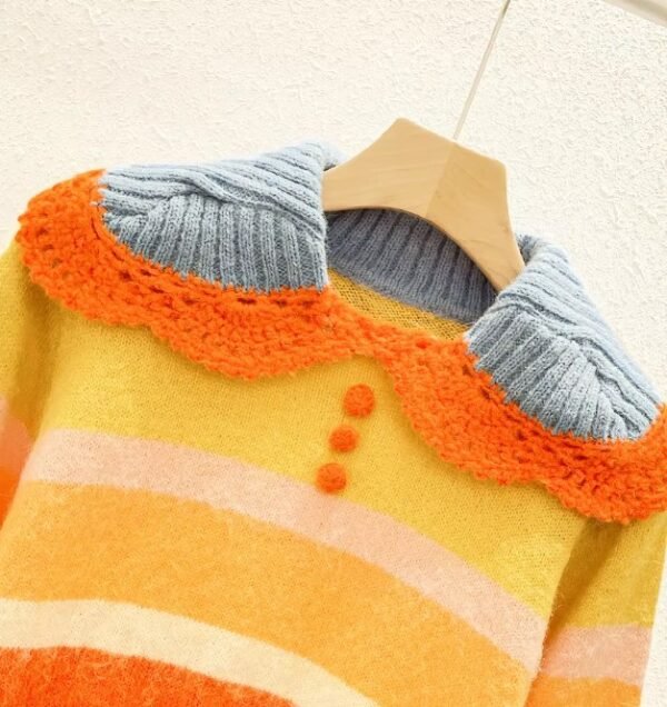 the collar of the cute orange sweater on a hanger