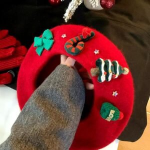 woman holding Christmas beret