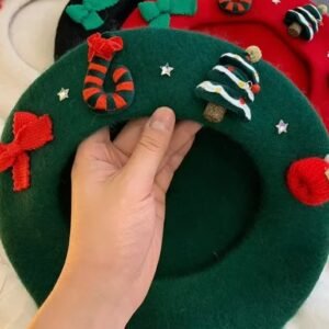 woman holding Christmas beret and exposing its side with decorations