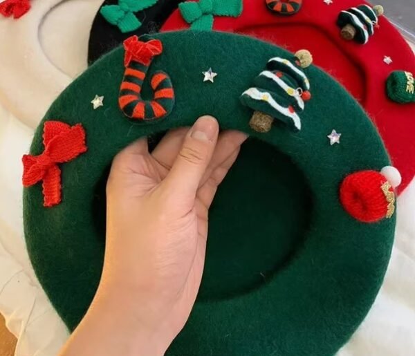 woman holding Christmas beret and exposing its side with decorations