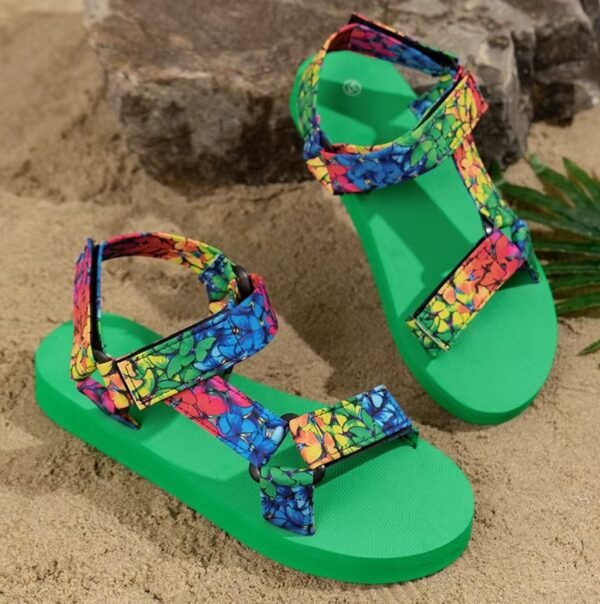 butterfly pattern colorful sandals standing on the sand