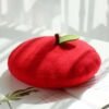 colorful apple beret on the white table