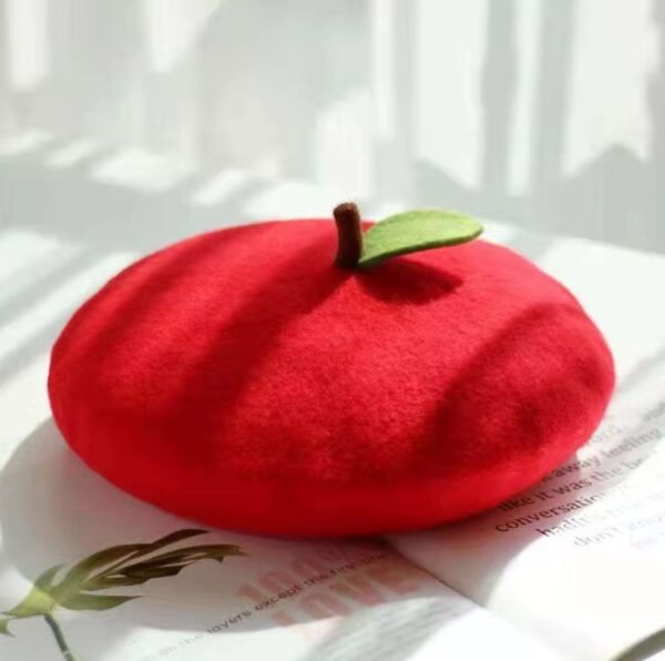 colorful apple beret on the white table