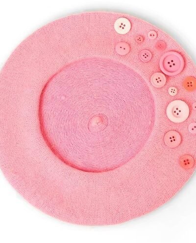 pale pink colorful beret with buttons on the white background