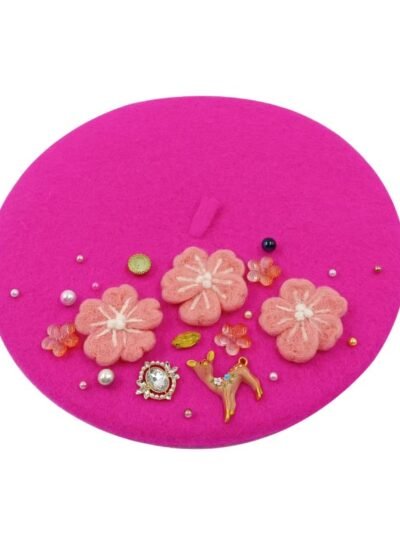 pink colorful decorated beret on the white background
