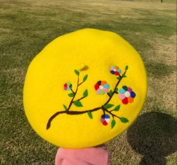 colorful embroidered beret, grass in the background