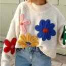 woman wearing colorful floral sweater