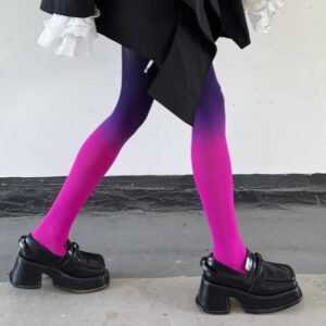 woman walking on a grey floor in purple colorful gradient tights and black shoes