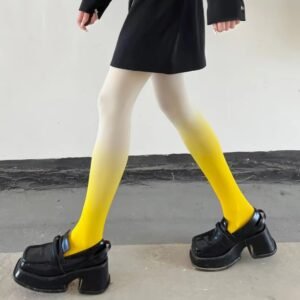 woman walking in yellow colorful gradient tights, black loafers and a black dress