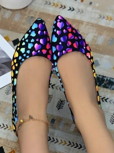 woman sitting in colorful hearts flats