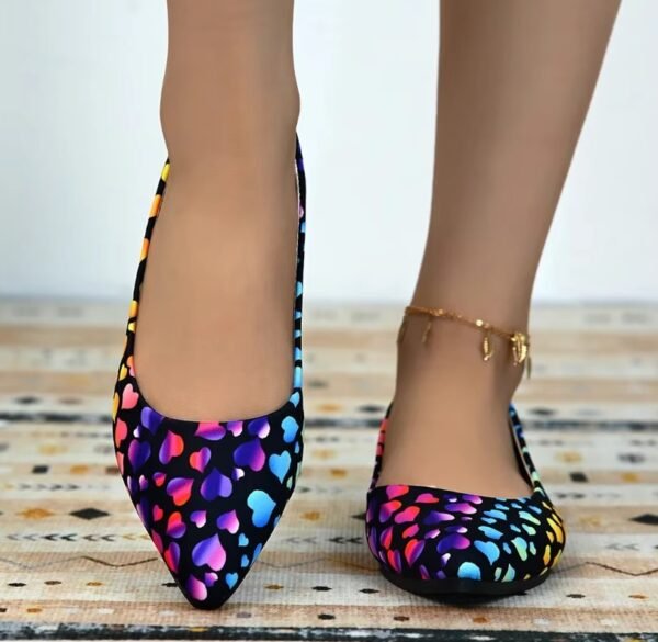 woman walking in colorful hearts flats on the wooden floor