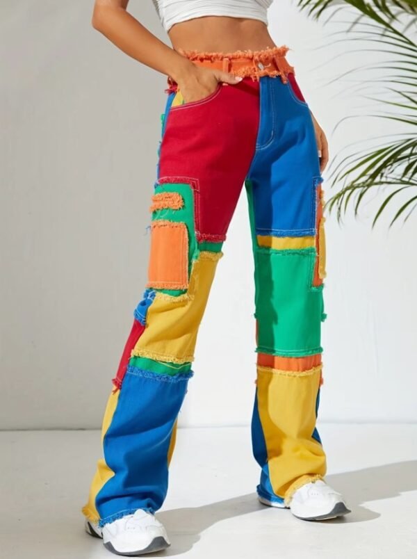 woman standing in colorful jeans in the white room