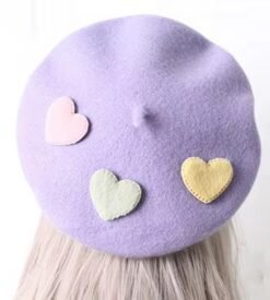 colorful pastel beret on blonde hair, white background