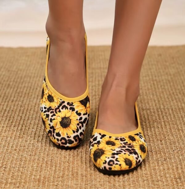 woman wearing colorful sunflower flats