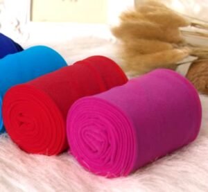 Colorful Tights Collection featuring rolled pink tights, red tights and blue tights on the white carpet