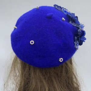 the back side of blue fancy colorful beret on a mannequin