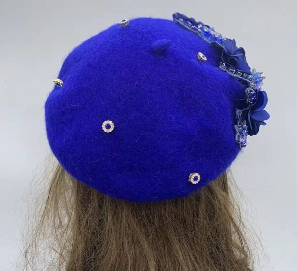 the back side of blue fancy colorful beret on a mannequin