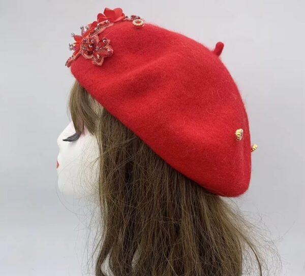 the side view of red fancy colorful beret on a mannequin