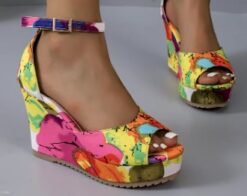 woman wearing multicolor wedges, grey floor under her