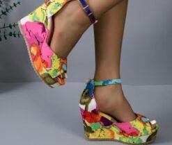 woman wearing multicolor wedges and lifting one feet