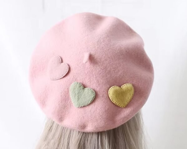 pink colorful pastel beret on blonde hair, white background