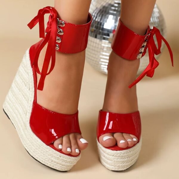 woman wearing red wedges, disco ball in the background