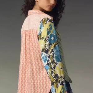 woman turned to her back wearing 90s colorful blouse, grey background