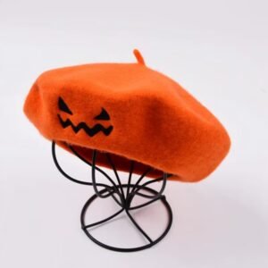 sideview on Halloween beret on a black pillar, white background