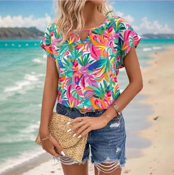 woman wearing Hawaiian colorful blouse, the beach in the background