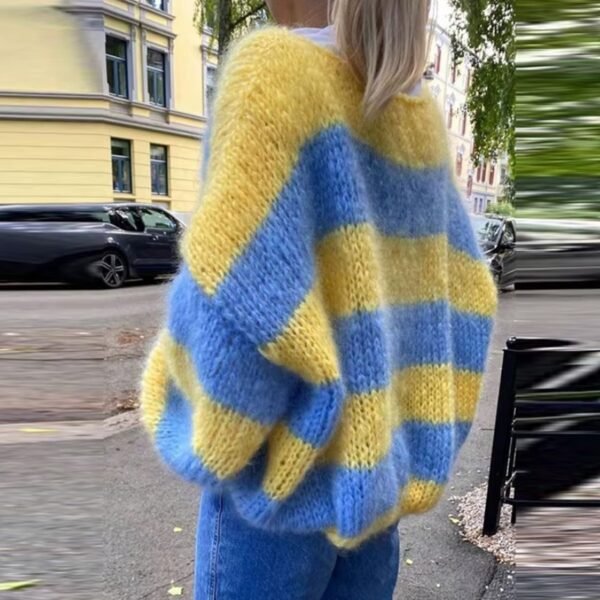 woman wearing blue and yellow colorful sweater, the street behind her