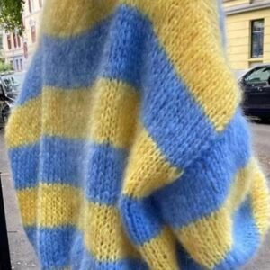 woman turned to her side wearing blue and yellow colorful sweater