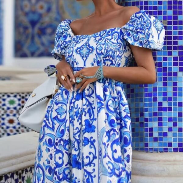 woman standing in a blue colorful bohemian dress exposing its upper part