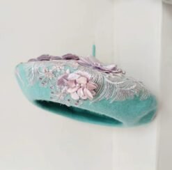 sideview of blue colorful lace beret on the white background
