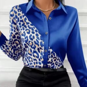 woman wearing blue leopard print colorful blouse and black jeans