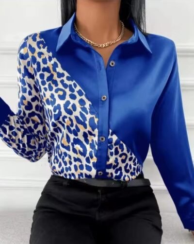 woman wearing blue leopard print colorful blouse and black jeans