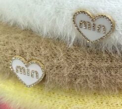 the material and the decorations of colorful beret with a pompom