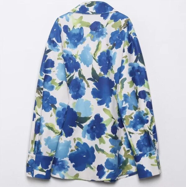 back view of colorful blouse with blue flowers on the white background